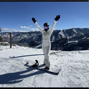 White ski suit with fur color and silver hardware. WORN ONCE.